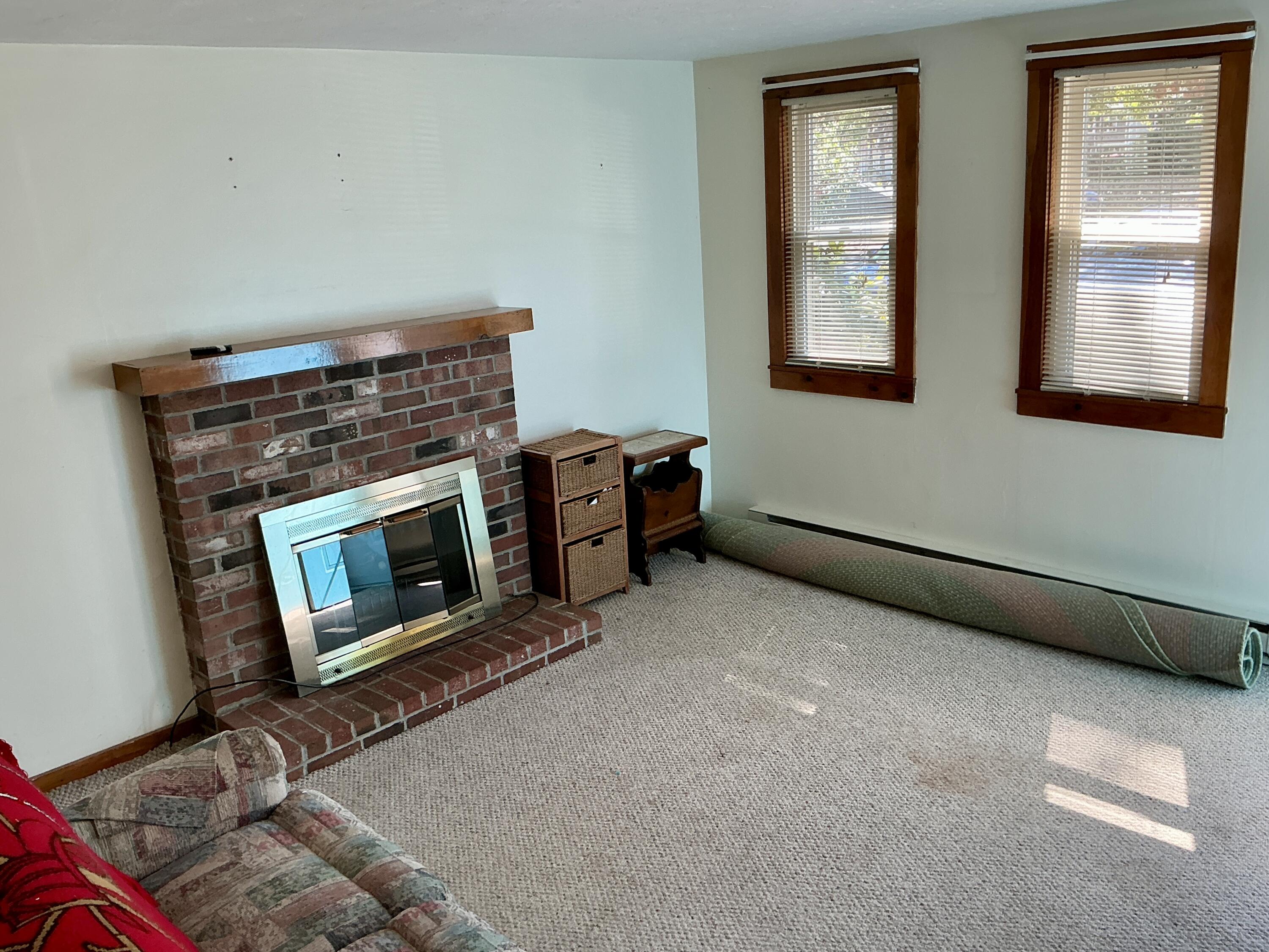 300 Falmouth Road, Unit 7E Mashpee, MA 02649 - Photo 16 of 27 a living room with furniture and a fireplace