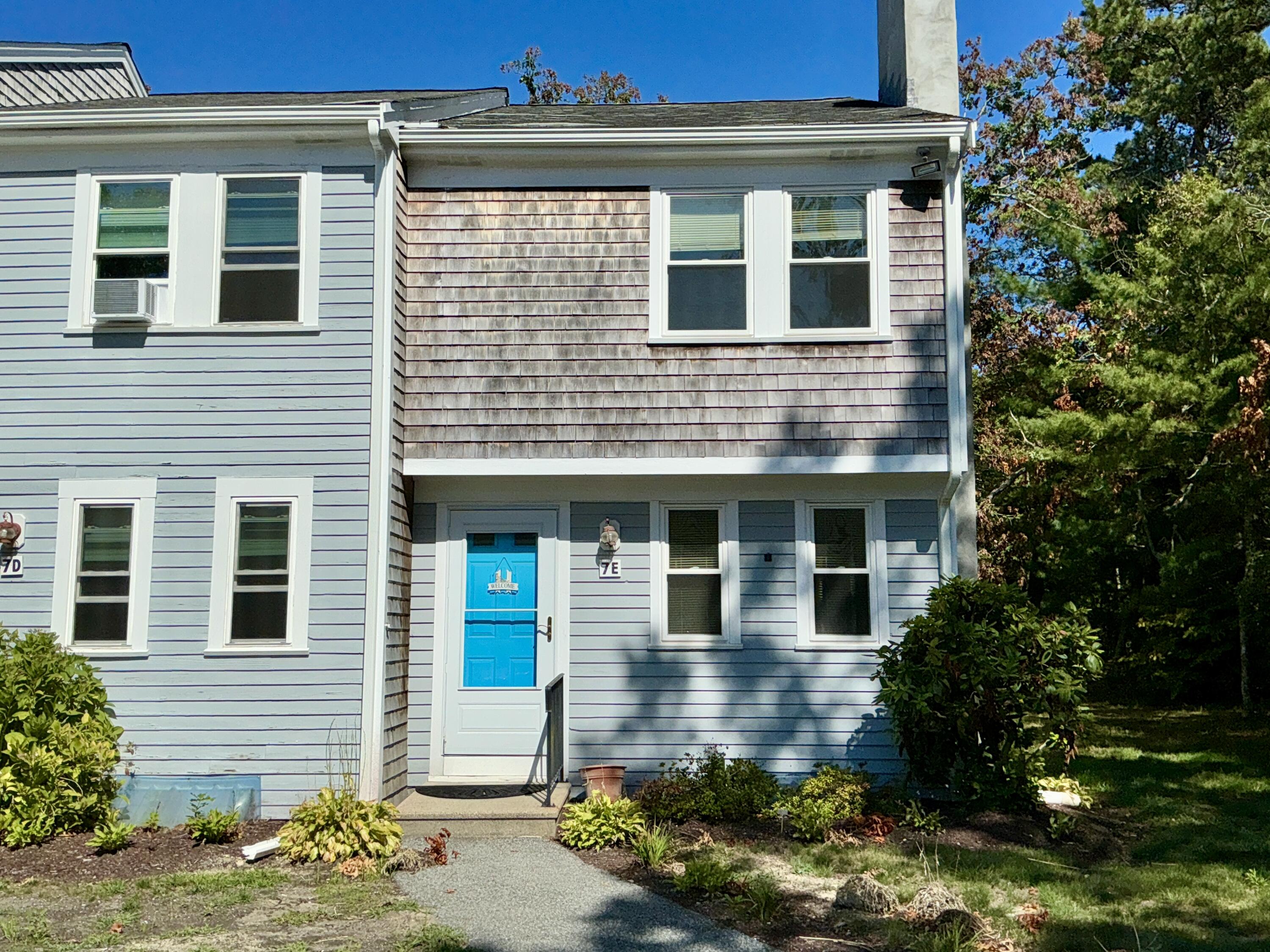 300 Falmouth Road, Unit 7E Mashpee, MA 02649 - Photo 3 of 27 a front view of a house with a yard