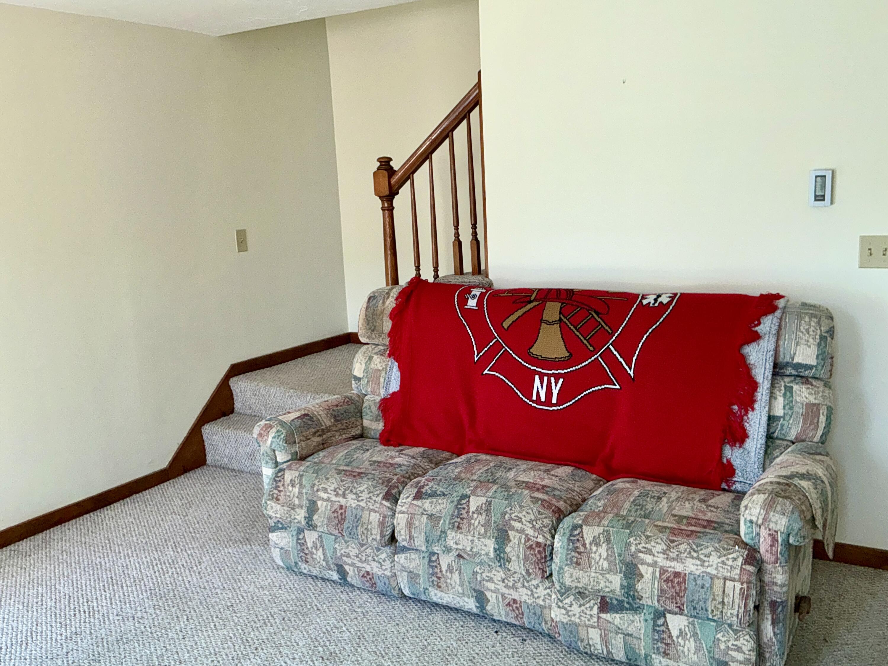 300 Falmouth Road, Unit 7E Mashpee, MA 02649 - Photo 5 of 27 a bedroom with a bed and a lamp with the wall