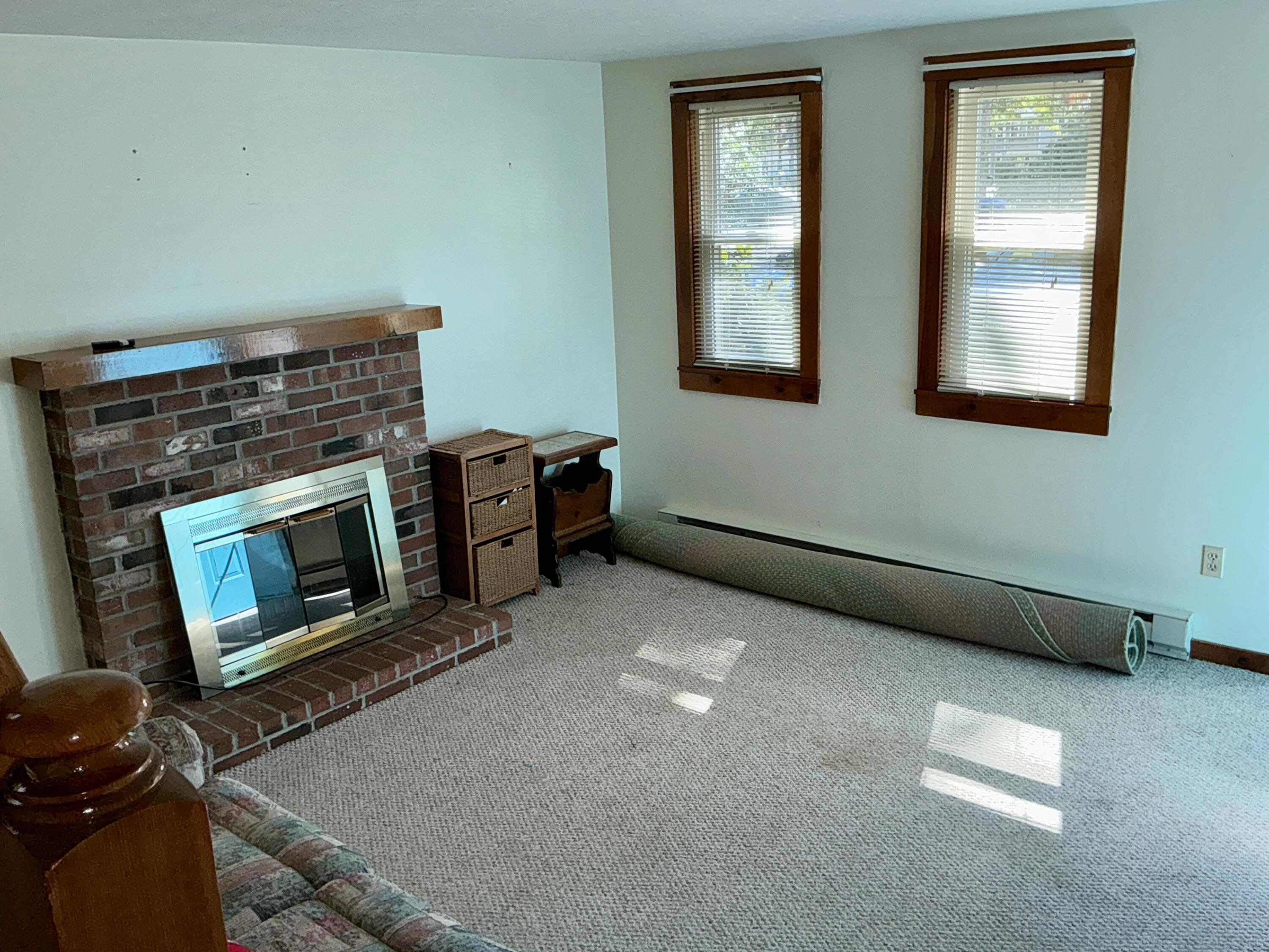 300 Falmouth Road, Unit 7E Mashpee, MA 02649 - Photo 6 of 27 a living room with furniture and a fireplace