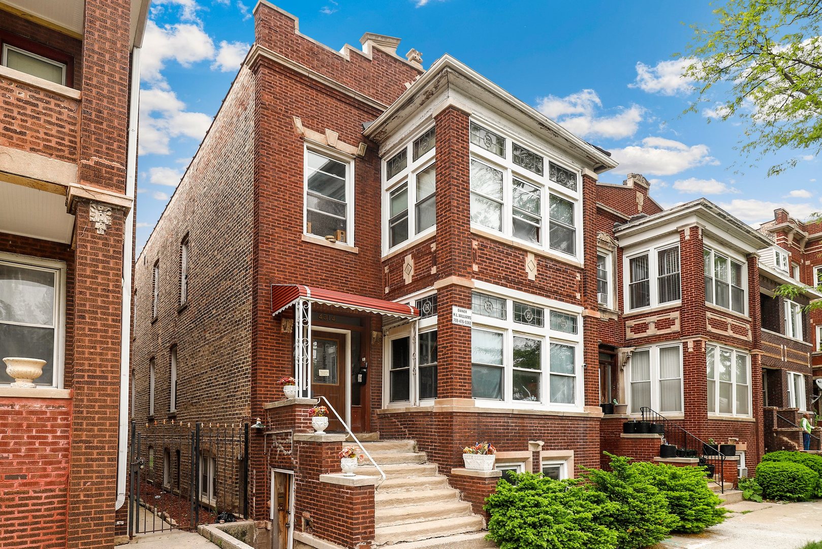 4314 West Cermak Road Chicago, IL 60623 - Photo 1 of 15 a front view of a residential apartment building with a yard