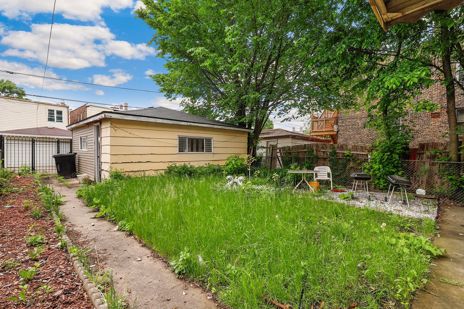 4314 West Cermak Road Chicago, IL 60623 - Photo 13 of 15 a front view of a house with a garden