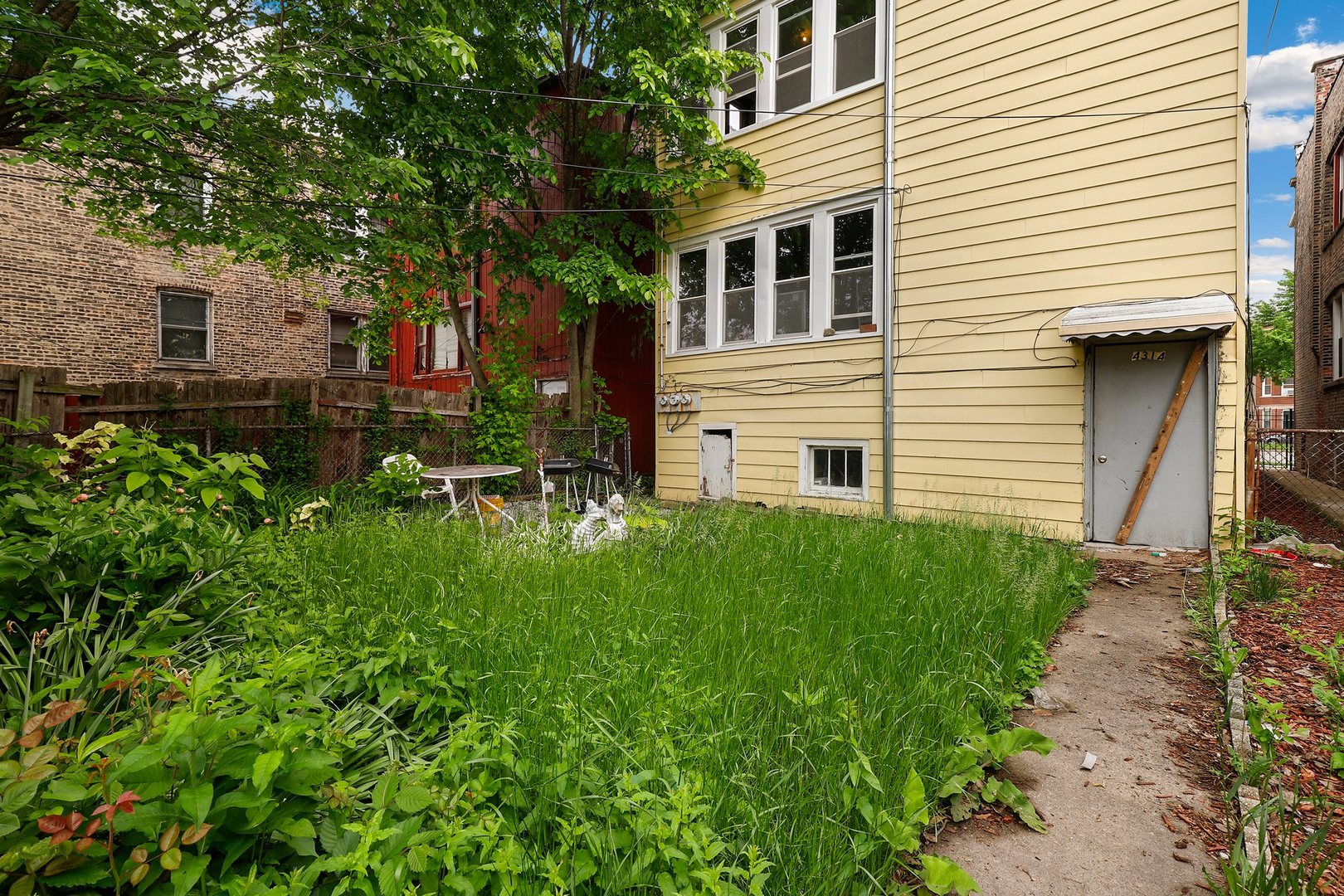 4314 West Cermak Road Chicago, IL 60623 - Photo 14 of 15 a view of a house with a yard