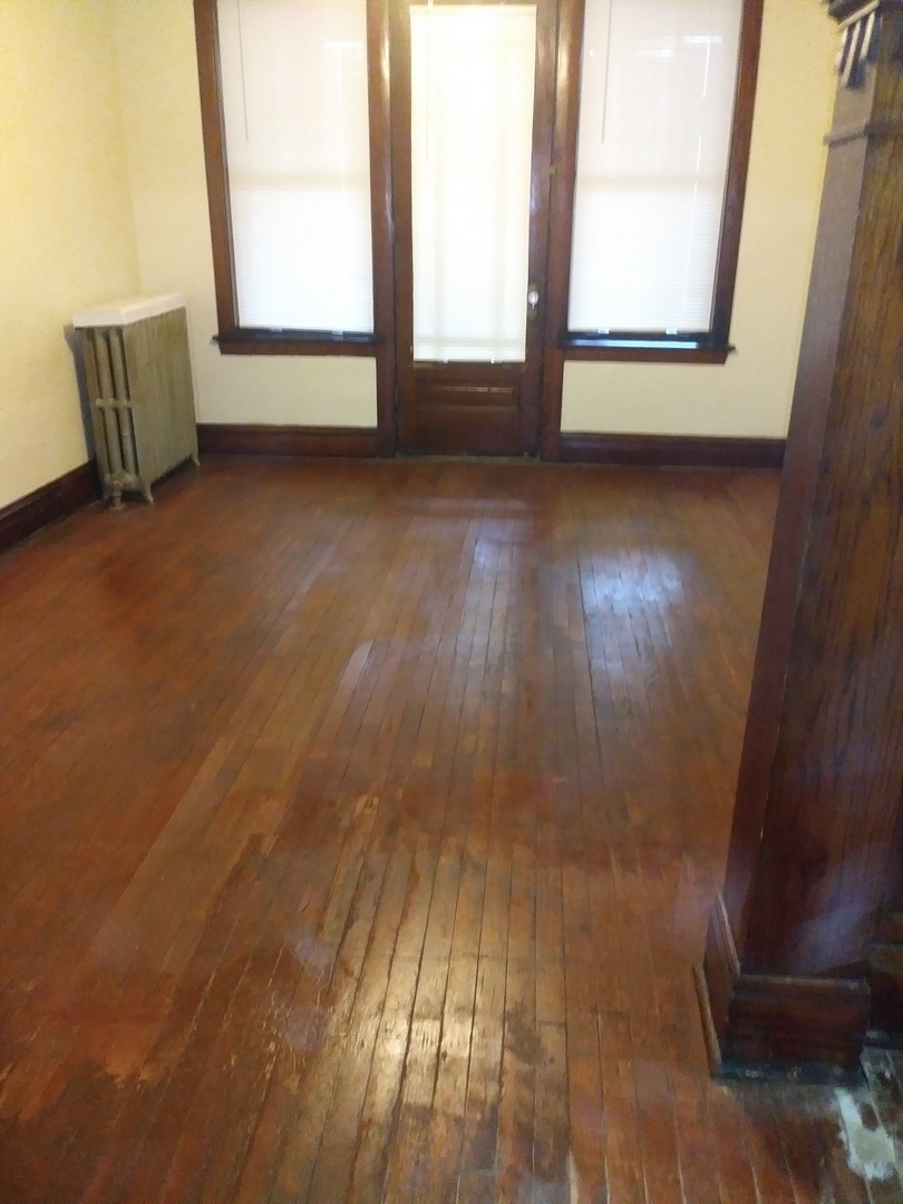 4314 West Cermak Road Chicago, IL 60623 - Photo 6 of 15 an empty room with wooden floor and windows