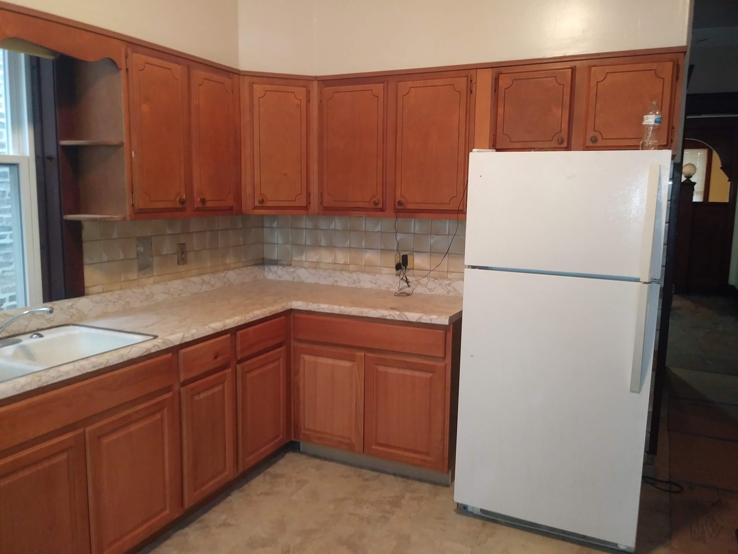 4314 West Cermak Road Chicago, IL 60623 - Photo 8 of 15 a kitchen with a refrigerator sink and cabinets