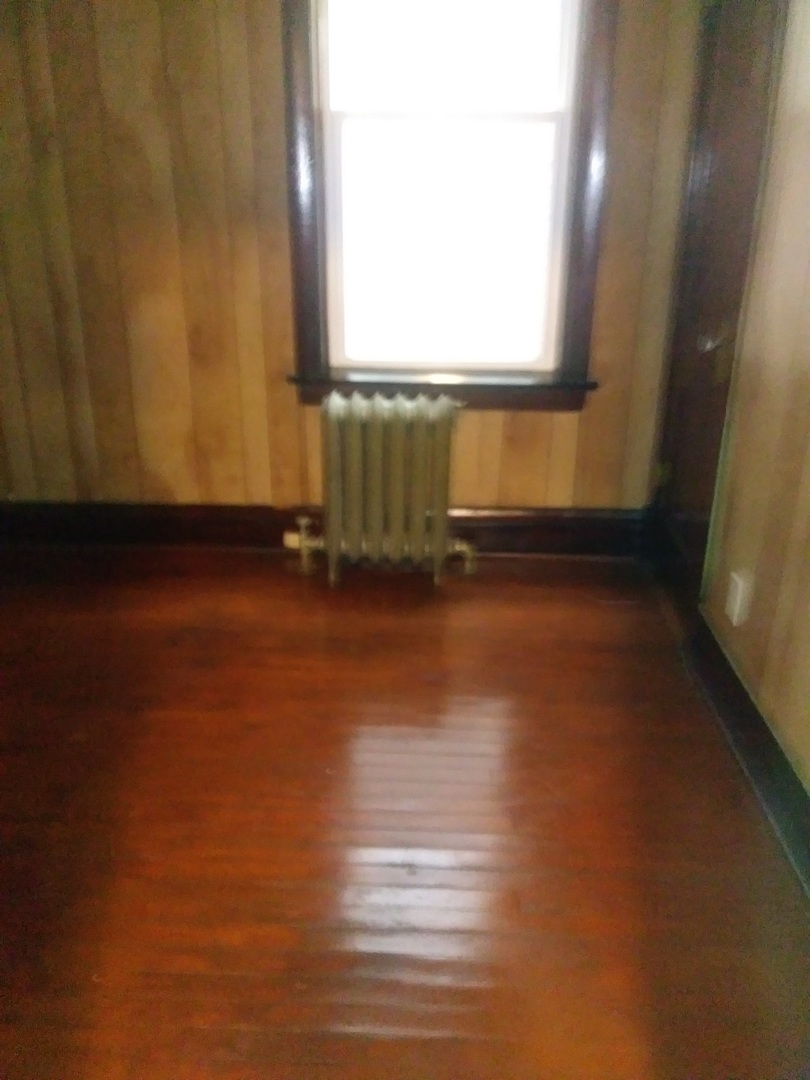 4314 West Cermak Road Chicago, IL 60623 - Photo 10 of 15 a view of a room with wooden floor and a window