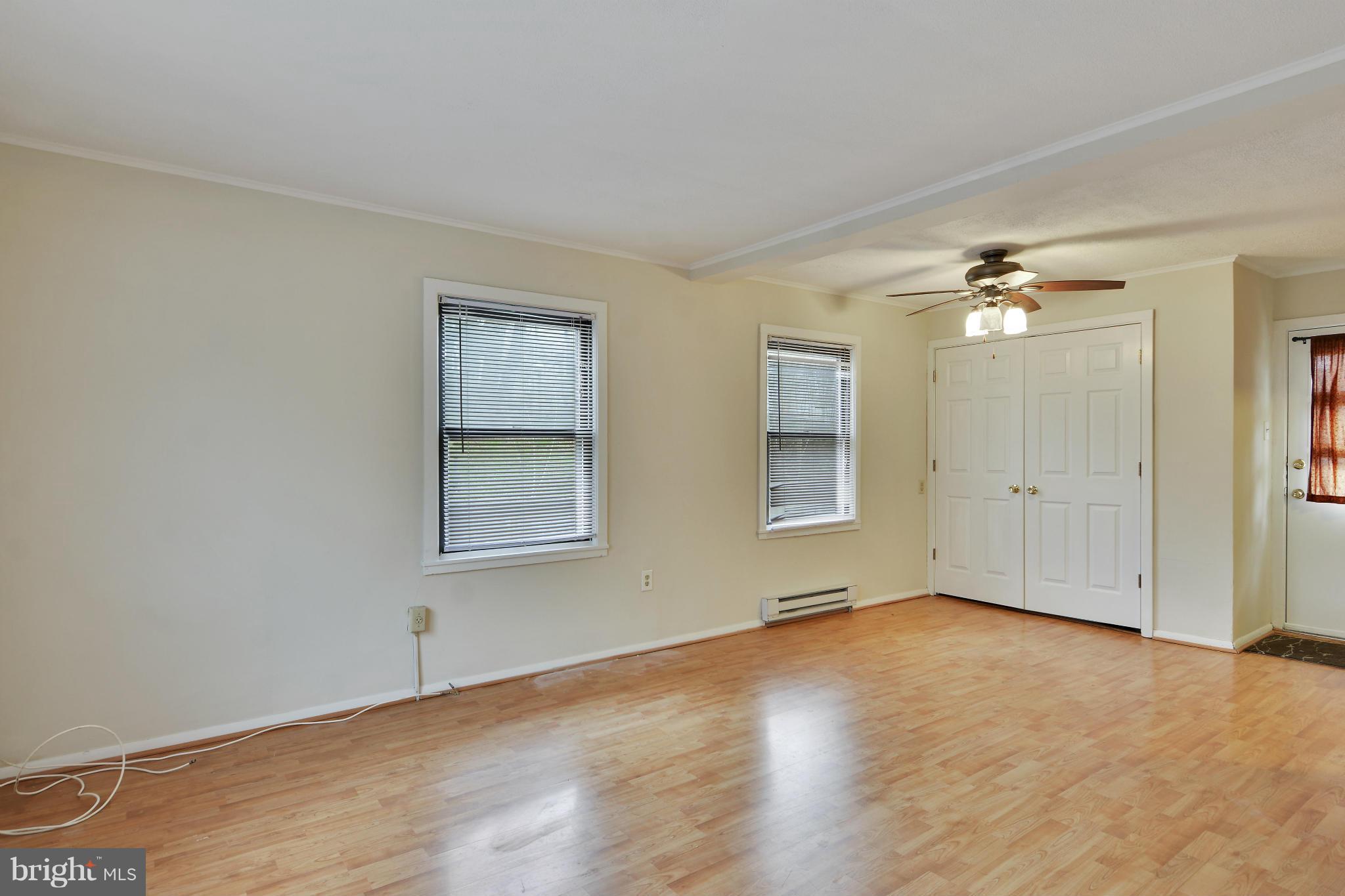 54 Ridge Road, Unit G Greenbelt, MD 20770 - Photo 8 of 30 an empty room with wooden floor and windows