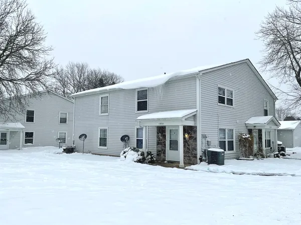 a view of a house with a snow on the road