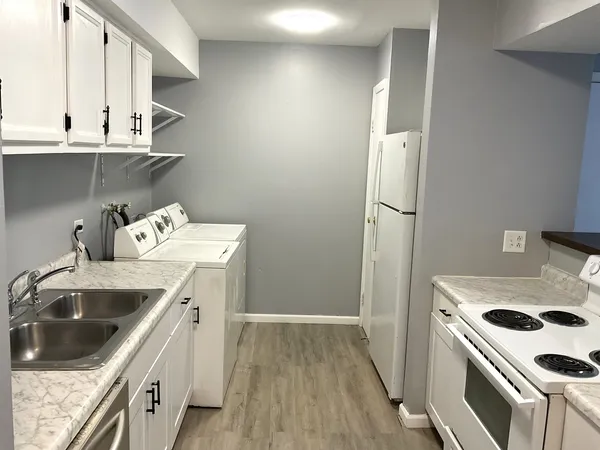 a kitchen with a sink a stove and refrigerator