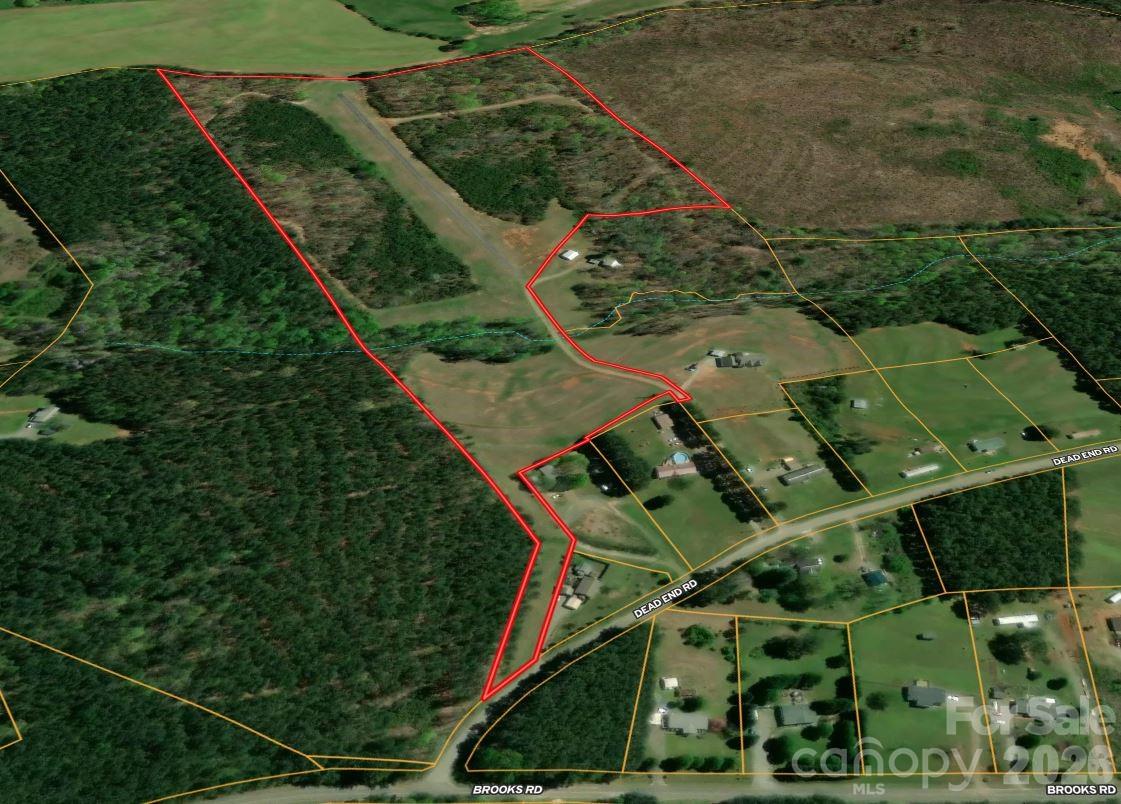 an aerial view of a residential houses with outdoor space