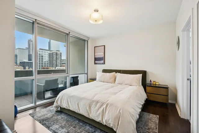 a bedroom with a bed and a night stand