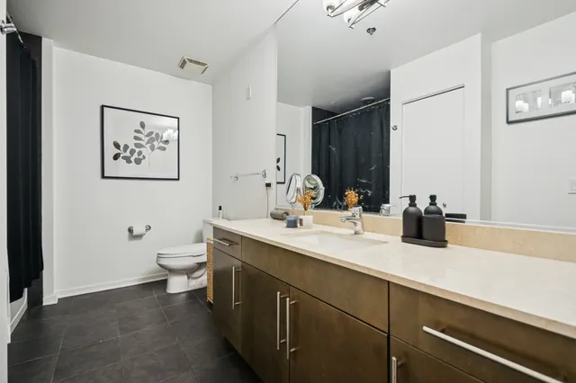 a bathroom with a sink a toilet and mirror