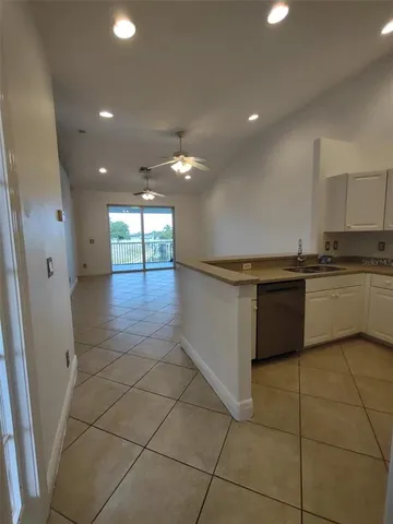 a kitchen with stainless steel appliances granite countertop a sink and cabinets