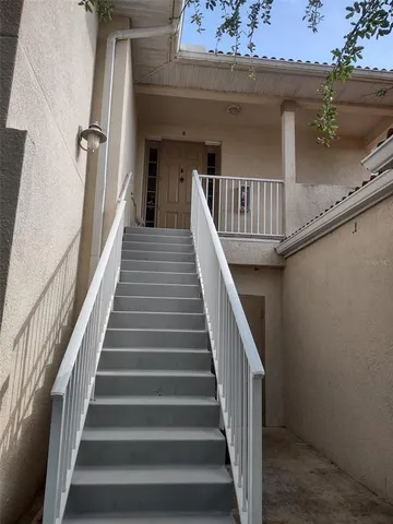 a view of staircase with railing and white walls