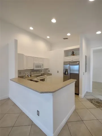 a kitchen with stainless steel appliances a sink and a refrigerator