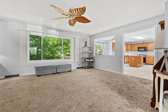 a kitchen with granite countertop a stove top oven microwave oven cabinets and a counter top space