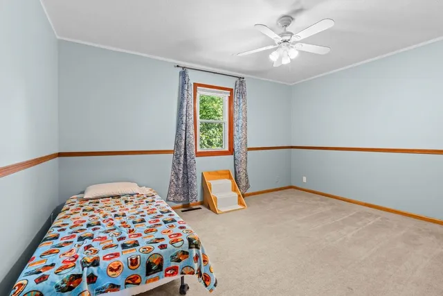 a white toilet sitting next to a white wall