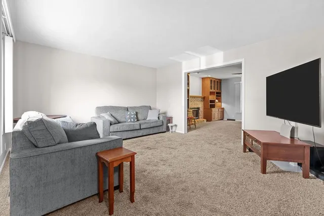 a view of a livingroom with furniture and a fireplace