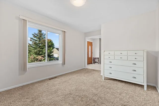 a kitchen with stainless steel appliances granite countertop wooden cabinets a stove a sink a dining table and chairs