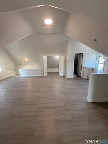 a view of a room with wooden floor