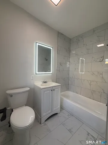 a bathroom with a sink toilet and bathtub