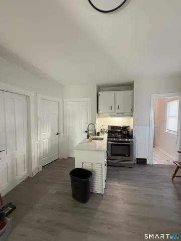 a kitchen with stainless steel appliances a stove and more cabinets