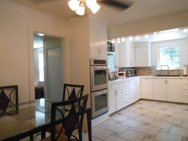 211 Randall Road Stow, MA 01775 - Photo 5 of 30 a large kitchen with a table and chairs