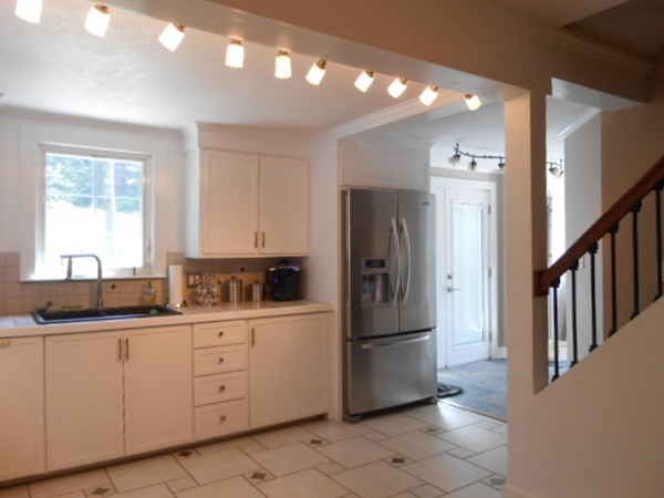 211 Randall Road Stow, MA 01775 - Photo 6 of 30 a kitchen with stainless steel appliances a refrigerator sink and cabinets