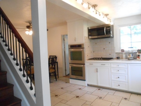 211 Randall Road Stow, MA 01775 - Photo 7 of 30 a kitchen with stainless steel appliances granite countertop a refrigerator and a stove top oven