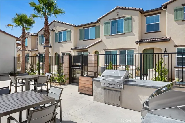 a view of a patio with table and chairs with wooden floor and fence