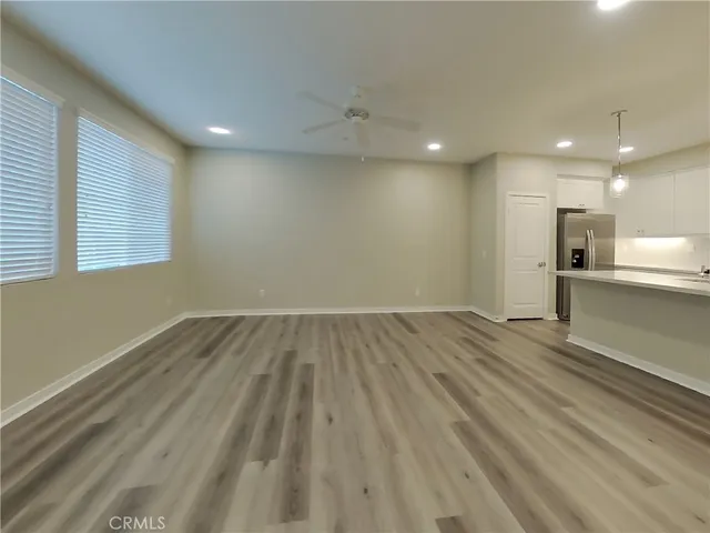 a view of a kitchen with a sink and wooden floor