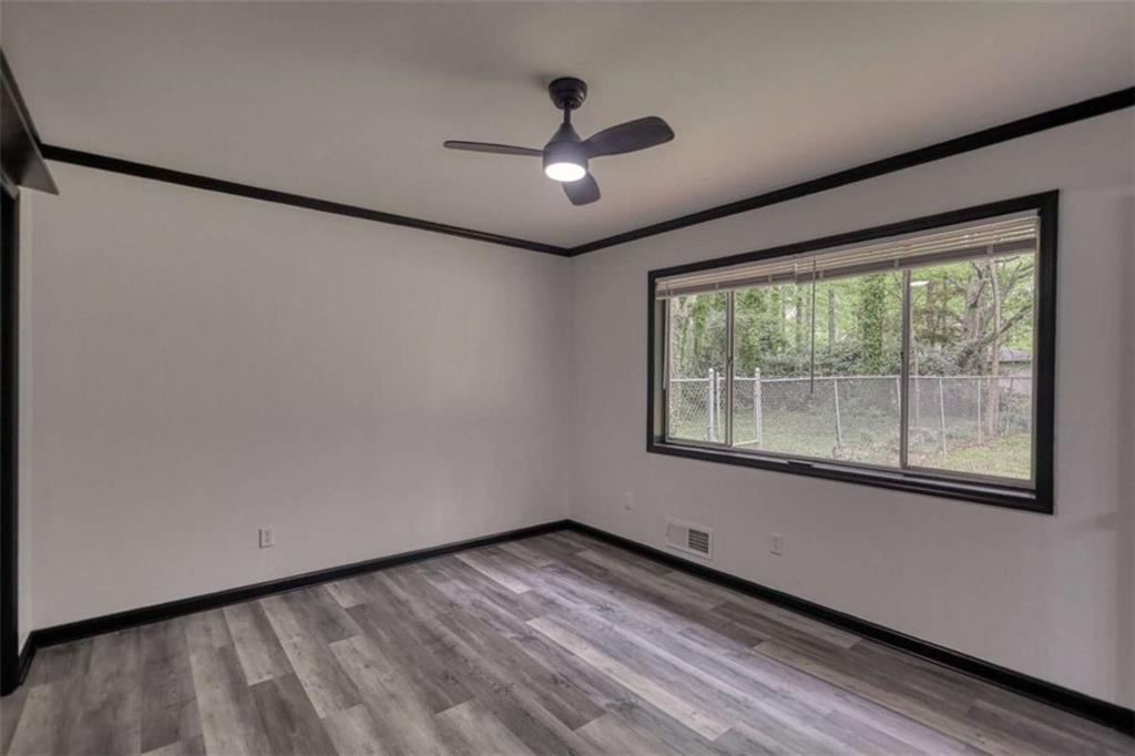 555 Joy Street Jackson, GA 30233 - Photo 40 of 56 a view of an empty room with wooden floor and a window