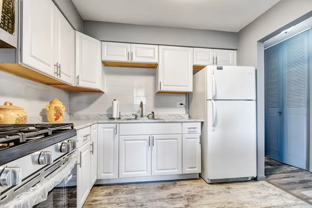 a white refrigerator freezer sitting inside of a kitchen