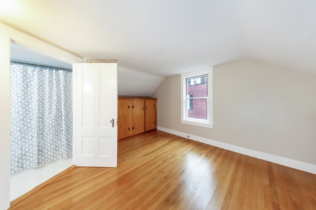 7 Herbert Street Salem, MA 01970 - Photo 11 of 17 wooden floor in an empty room with a window