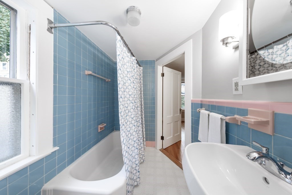 7 Herbert Street Salem, MA 01970 - Photo 12 of 17 a bathroom with a sink a toilet and shower