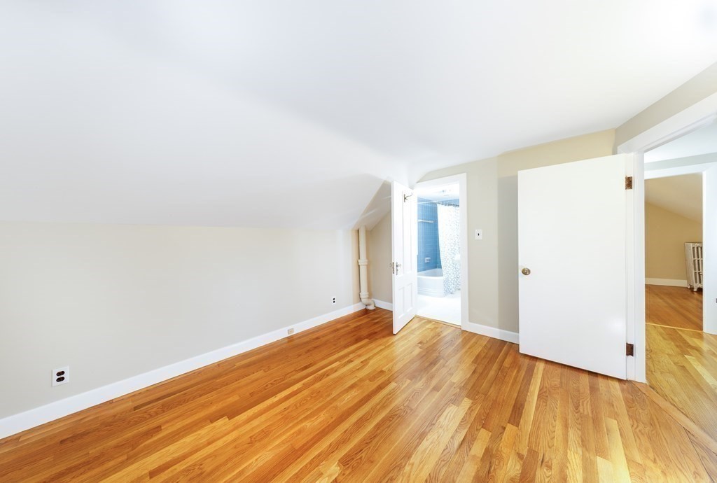 7 Herbert Street Salem, MA 01970 - Photo 13 of 17 a view of an empty room with wooden floor and a window