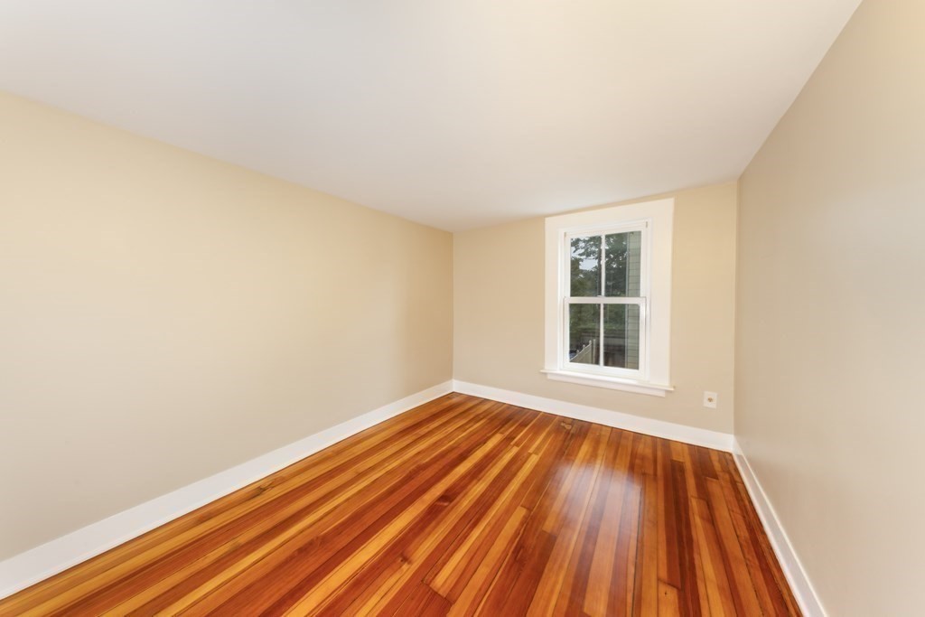 7 Herbert Street Salem, MA 01970 - Photo 14 of 17 a view of an empty room with wooden floor and a window