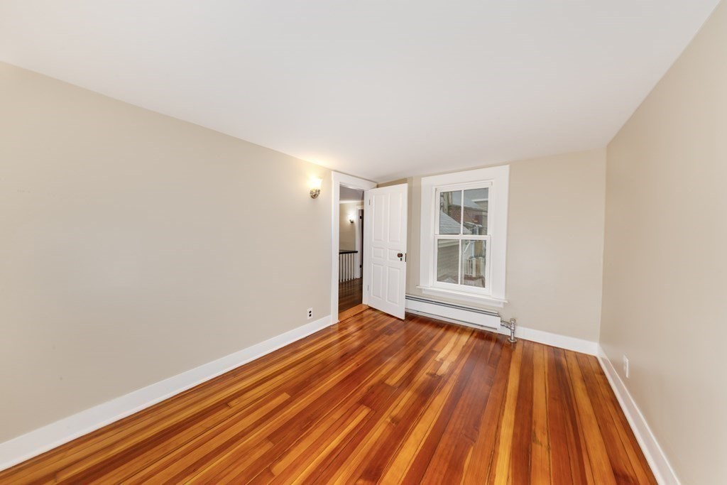 7 Herbert Street Salem, MA 01970 - Photo 15 of 17 a view of an empty room with wooden floor and a window