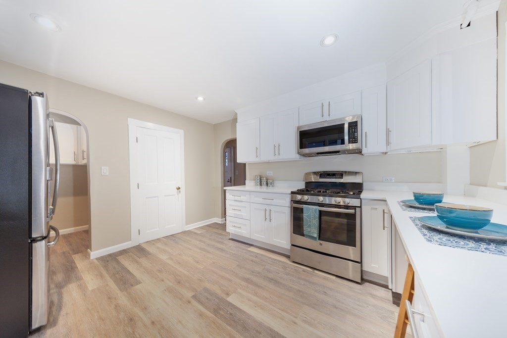 7 Herbert Street Salem, MA 01970 - Photo 2 of 17 a kitchen with stainless steel appliances granite countertop a stove a sink and a refrigerator