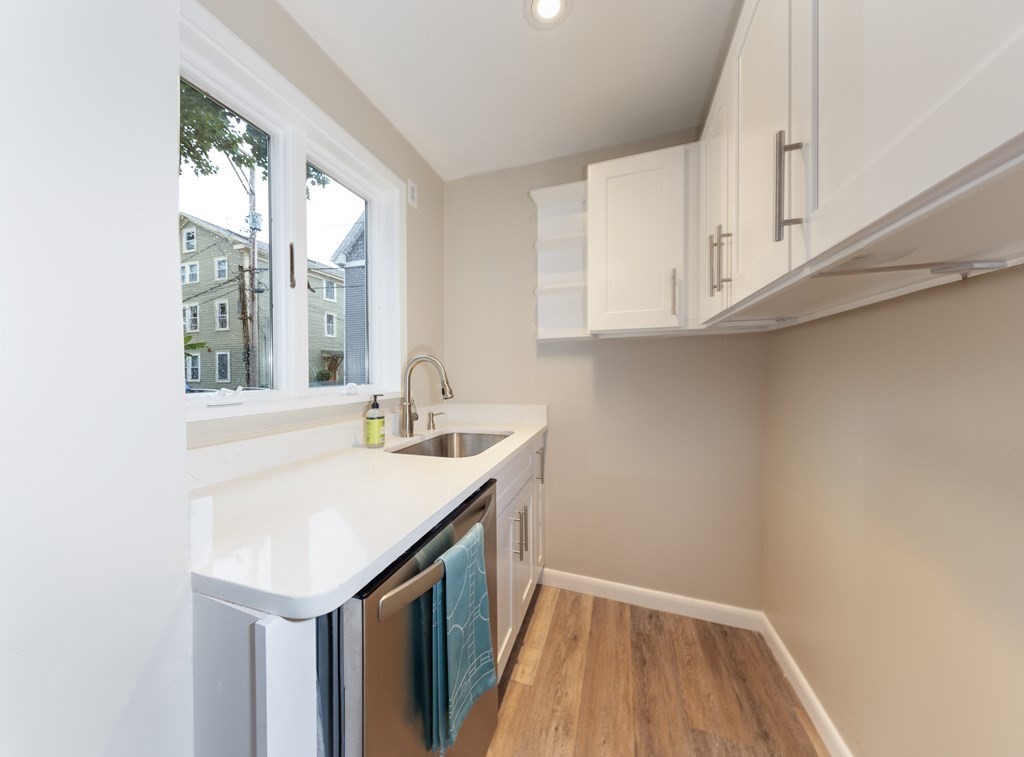 7 Herbert Street Salem, MA 01970 - Photo 4 of 17 a kitchen with sink cabinets and wooden floor