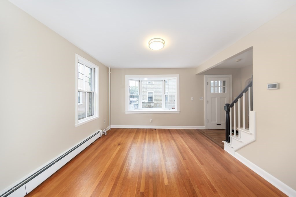 7 Herbert Street Salem, MA 01970 - Photo 5 of 17 an empty room with wooden floor and windows