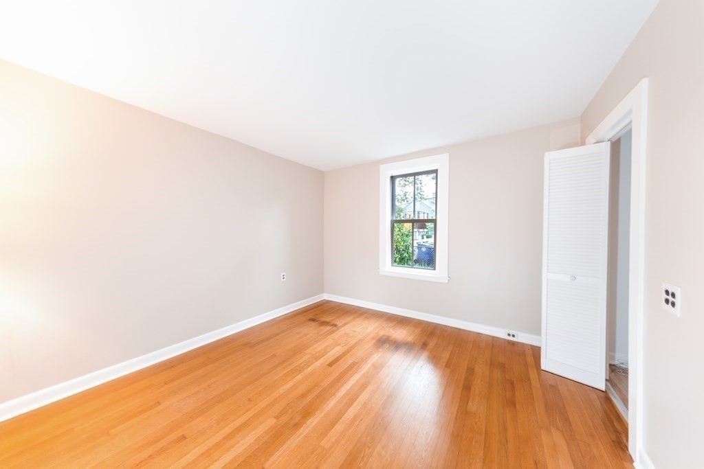 7 Herbert Street Salem, MA 01970 - Photo 7 of 17 an empty room with wooden floor and windows