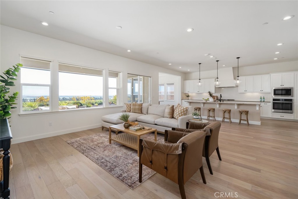 a living room with lots of furniture and a large window