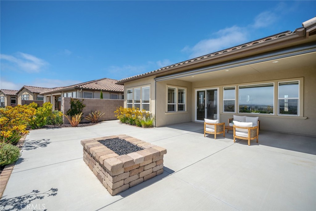 1622 Eucalyptus Road Nipomo, CA 93444 - Photo 23 of 73 a view of a house with backyard sitting area and porch