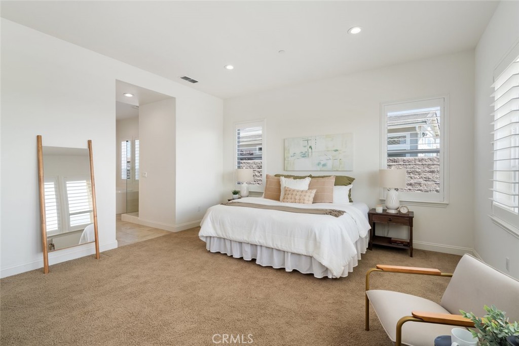 1622 Eucalyptus Road Nipomo, CA 93444 - Photo 26 of 73 a spacious bedroom with a bed and glass door