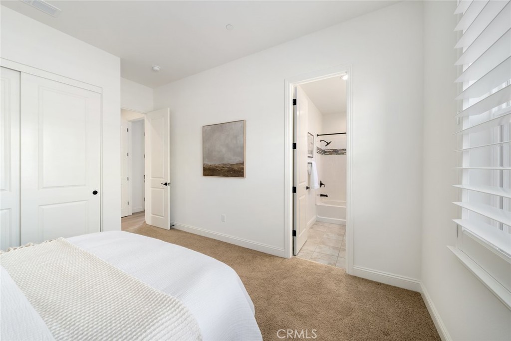 1622 Eucalyptus Road Nipomo, CA 93444 - Photo 34 of 73 a bedroom with a bed and bathroom