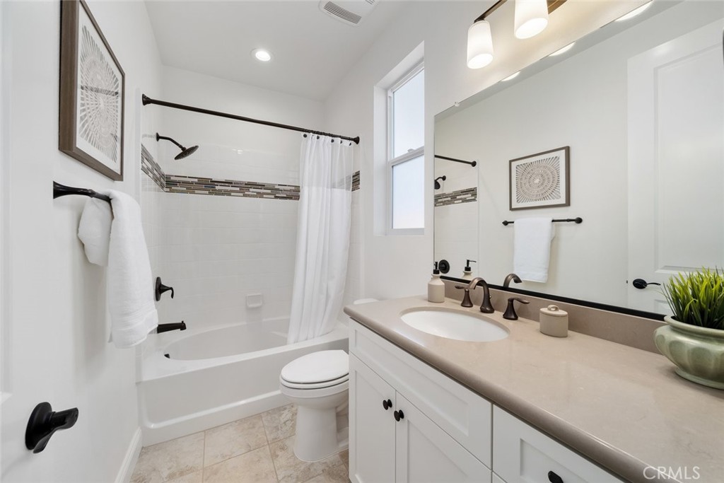 1622 Eucalyptus Road Nipomo, CA 93444 - Photo 35 of 73 a bathroom with a granite countertop sink a toilet and shower