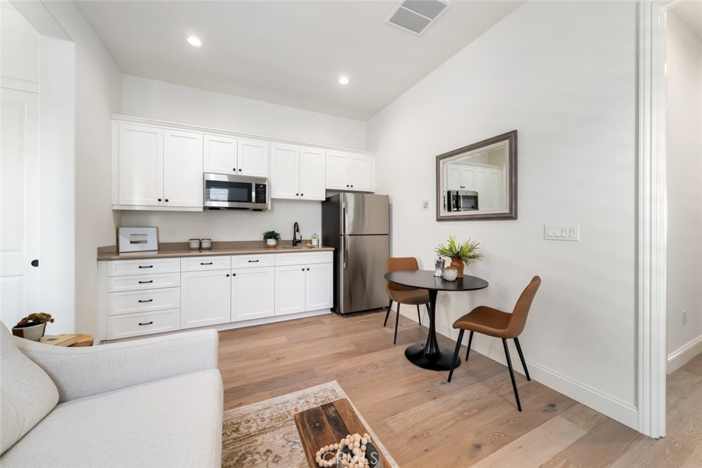 1622 Eucalyptus Road Nipomo, CA 93444 - Photo 47 of 73 a kitchen with stainless steel appliances kitchen island granite countertop a refrigerator and cabinets