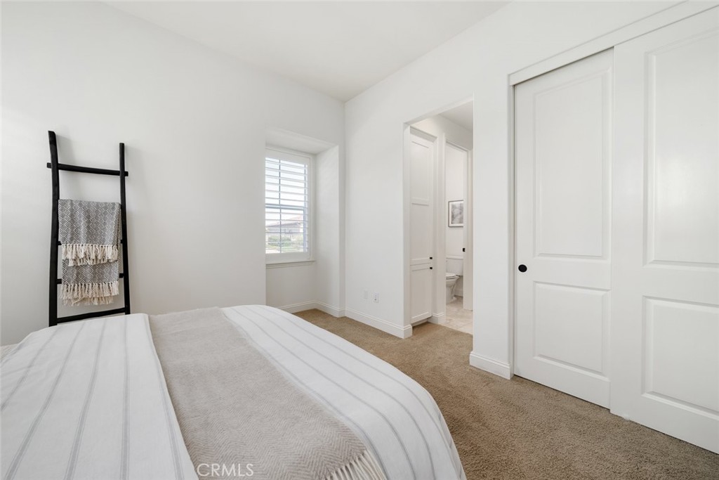 1622 Eucalyptus Road Nipomo, CA 93444 - Photo 50 of 73 a bedroom with a bed and a mirror