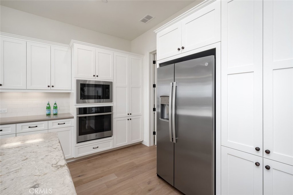 1622 Eucalyptus Road Nipomo, CA 93444 - Photo 8 of 73 a kitchen with stainless steel appliances cabinets and a refrigerator